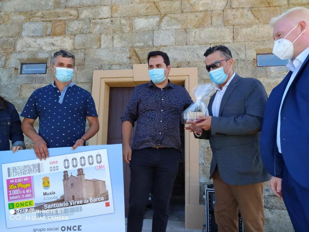 Imaxe dos protagonistas do acto tralo intercambio de agasallos entre o delegado da ONCE e o alcalde de Muxía